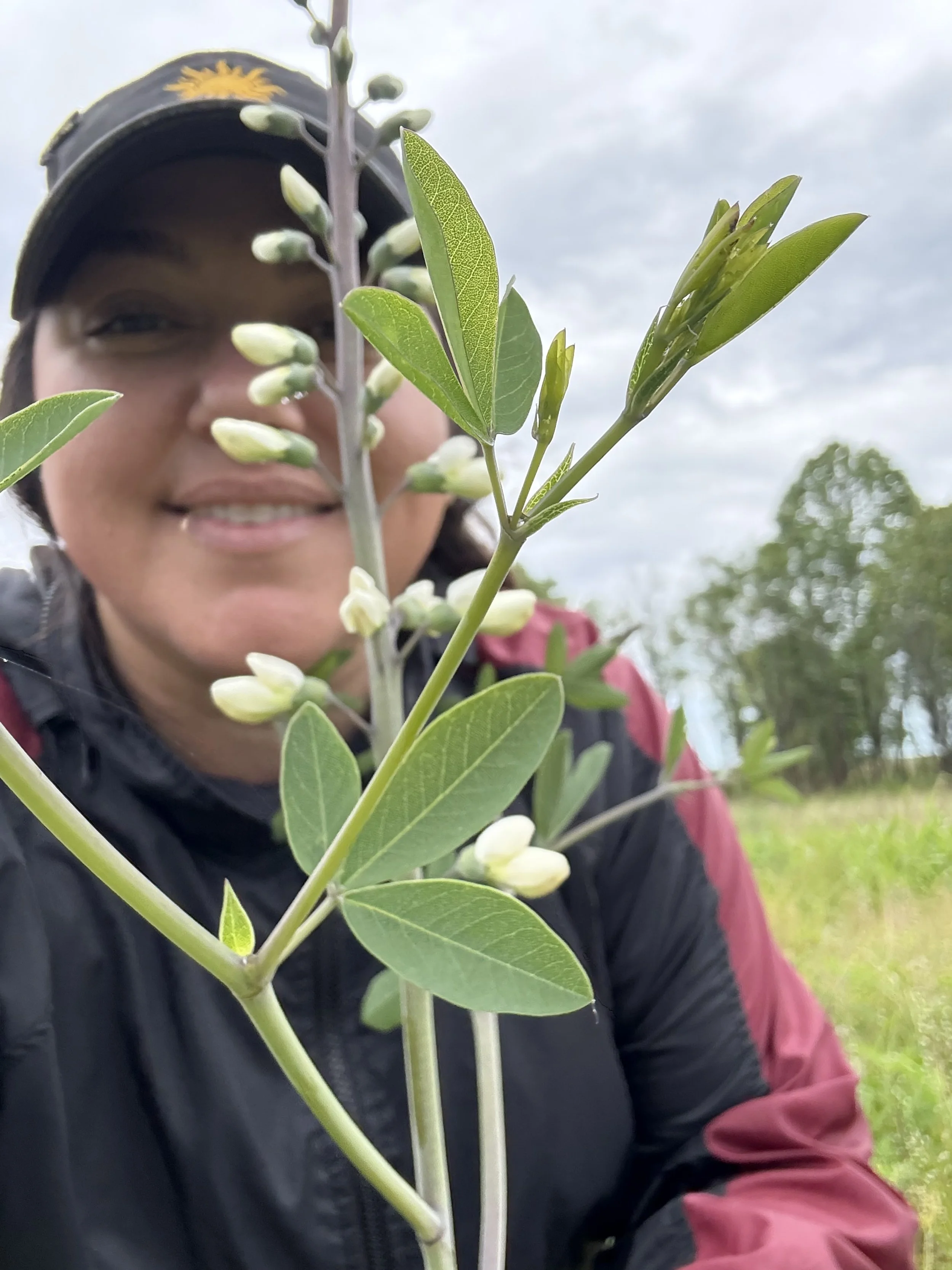 Katie_in front of a budding plant.jpeg