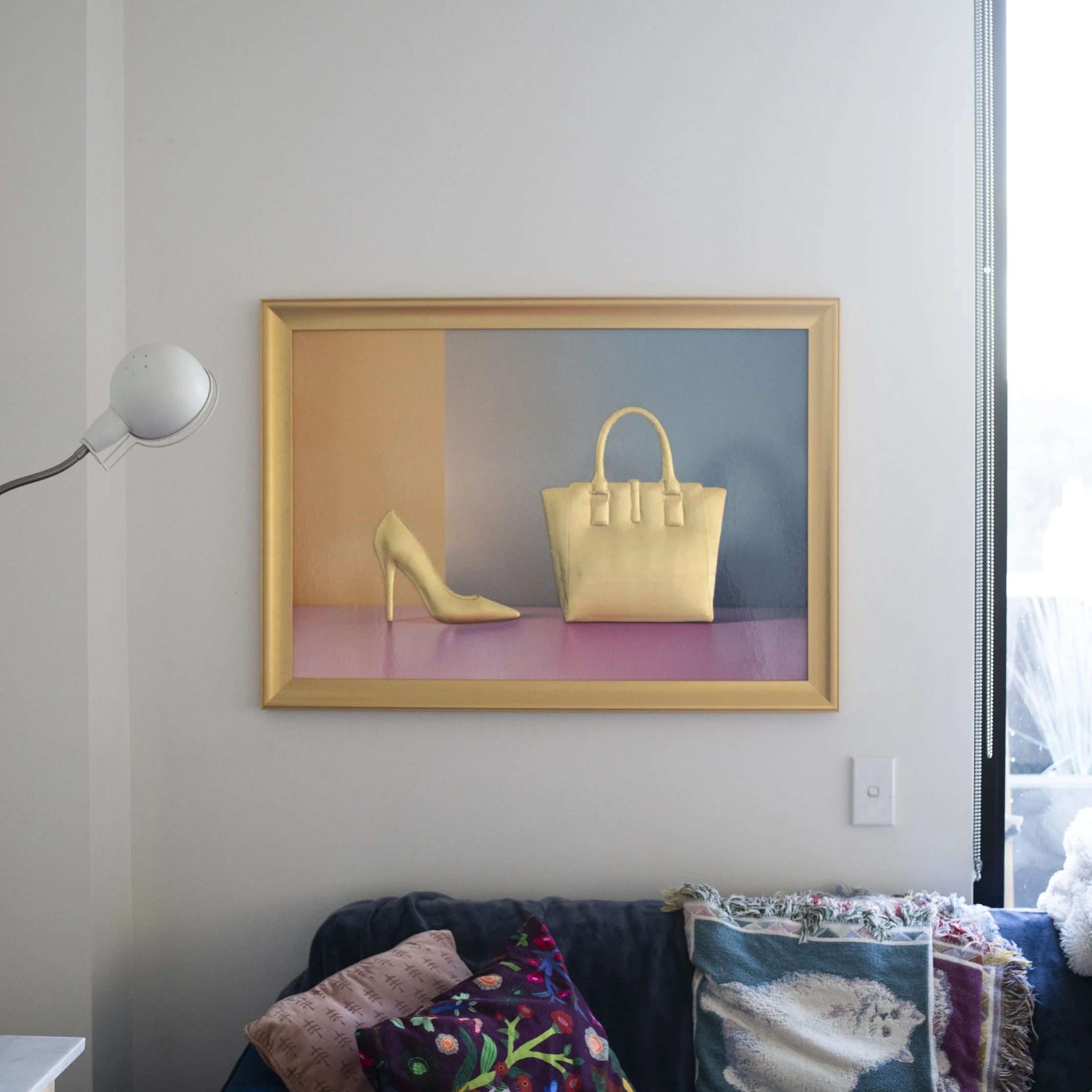 24k Gold Leaf 3D Shoe and Handbag Sculpture: Photographic Art on Bold Colour Background – Original Art by Rory Fink in living room setting 2