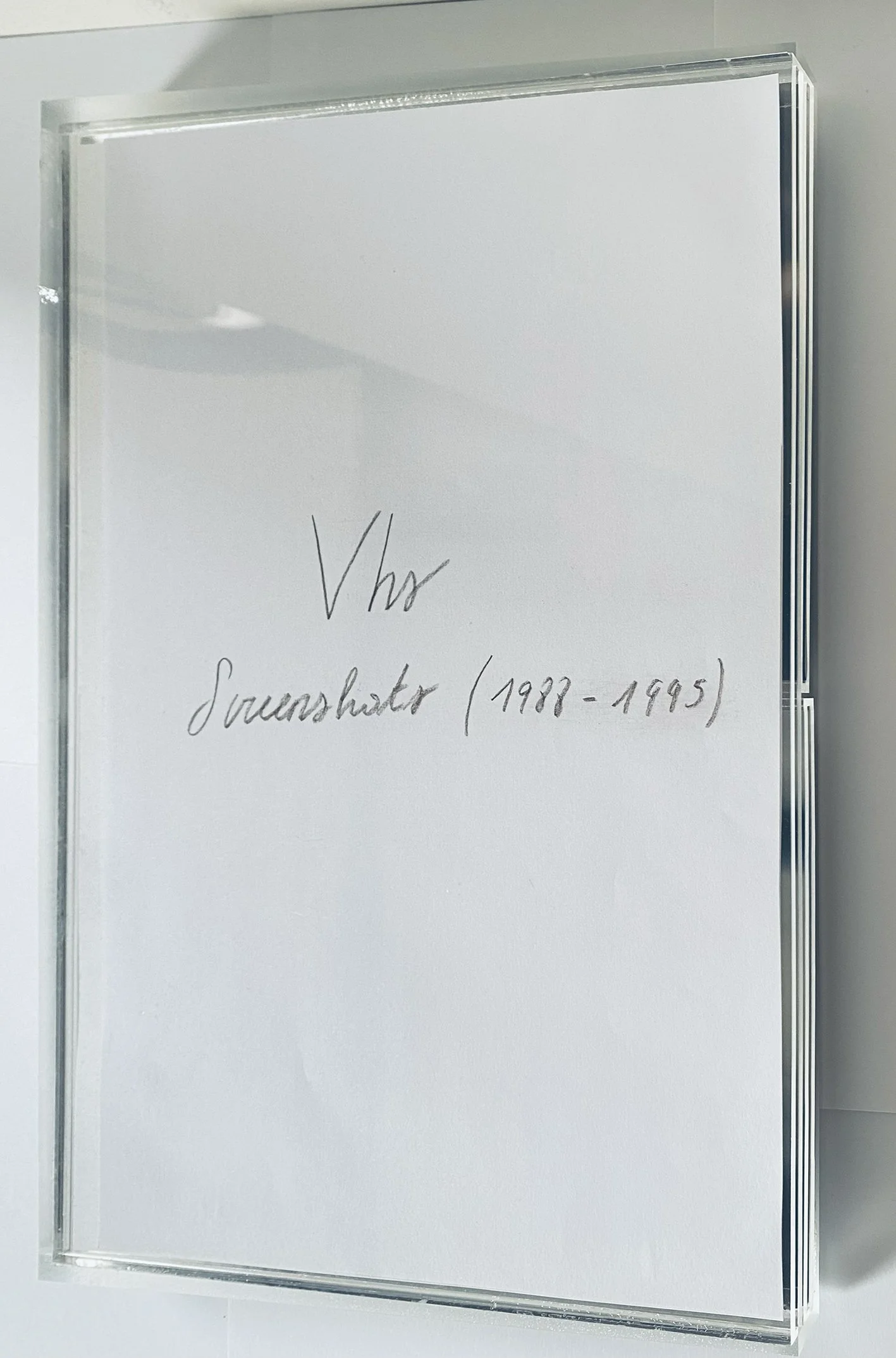   VHS Screenshots, 2025                                                                               Unique box with VHS screenshots of old footage,                                             Printed material and mixed media, cm 30 × 20 