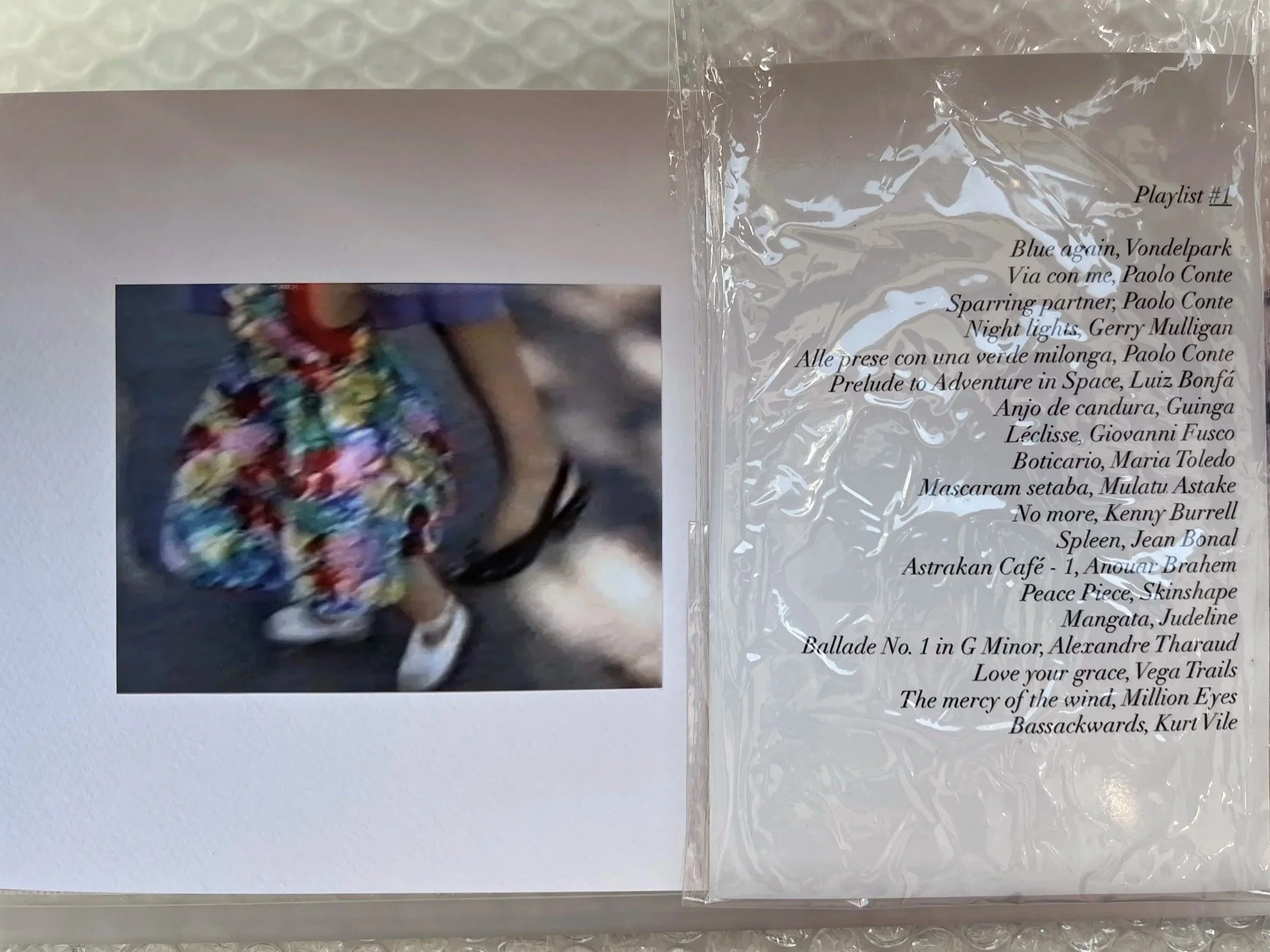    Untitled (Box)  ,   2025 Plexiglass, glossy prints, textile fragment, pastel drawing, and playlist (three generations) 