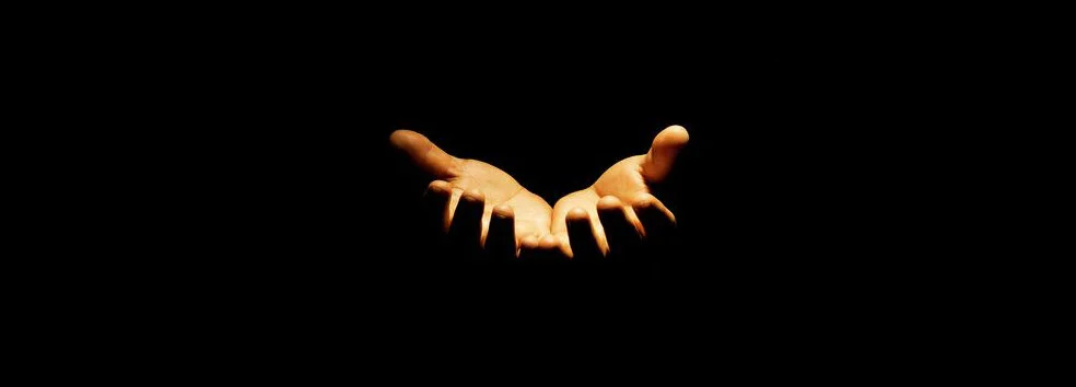 61145395-praying-hands-in-black-background.jpg
