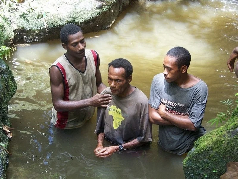 Topa Tamana being baptised.