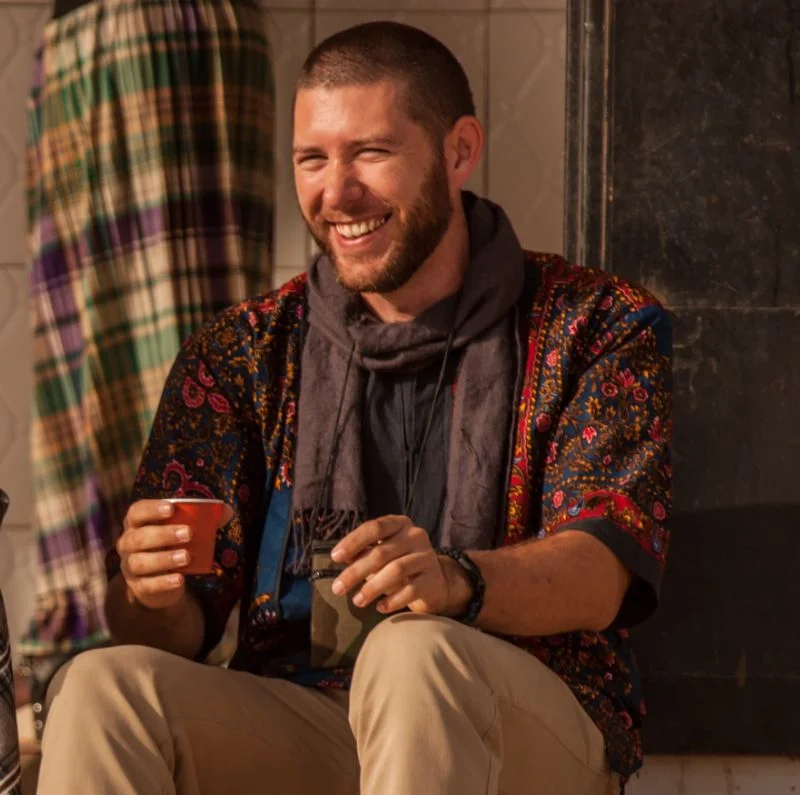 missionary man holding cup and smiling