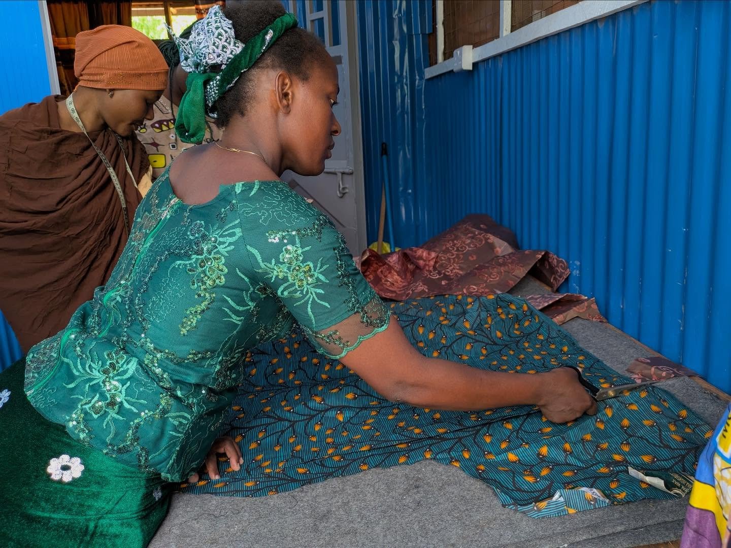 Meet Mama Bade ✂️🧵
(Slide 2: pictured left | Slide 3: pictured far right)

Mama Bade&rsquo;s story is one of becoming.

She is a Burundian refugee who arrived at Kakuma Refugee Camp in 2011 after fleeing Burundi&mdash;carrying resilience, hope, and 