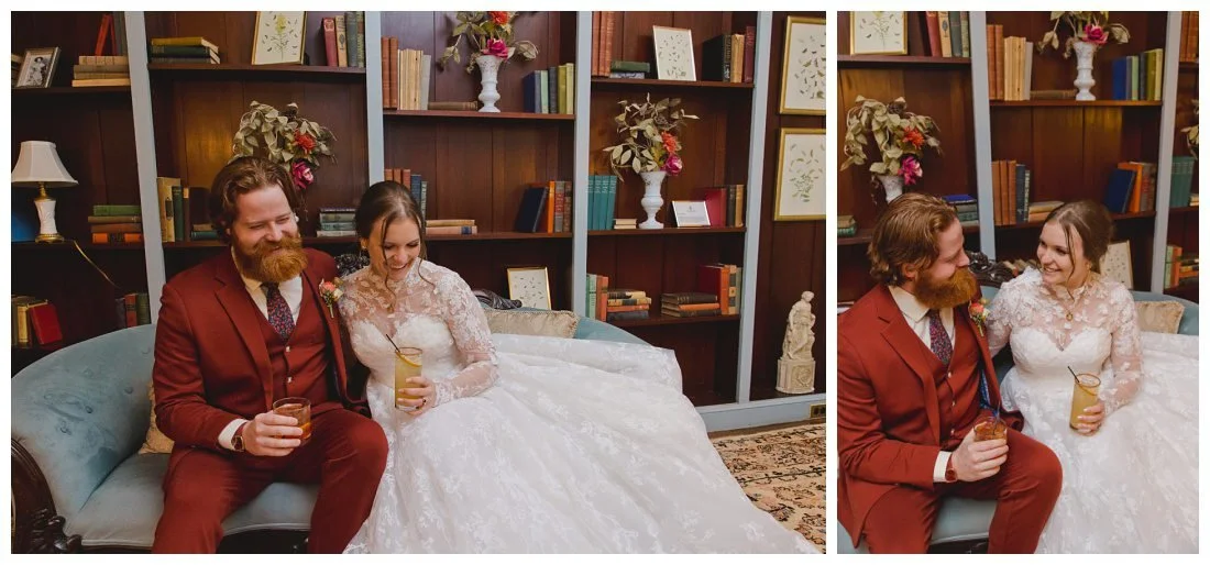 bride and groom have cocktails while sitting on the couch in the library at glen magna