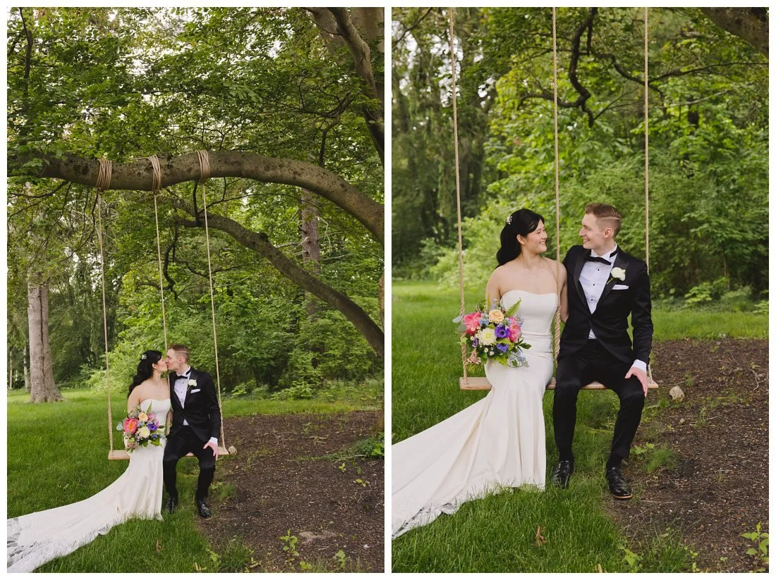 wedding couple sit on wooden swing that hangs from old tree at the evermore