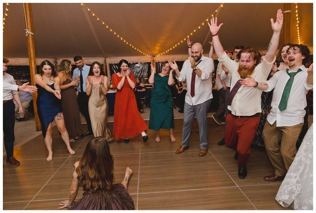 guest does a split on the dance floor and everyone goest crazy laughing and cheering