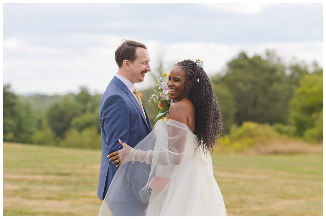 bride and groom laughing and holding each other