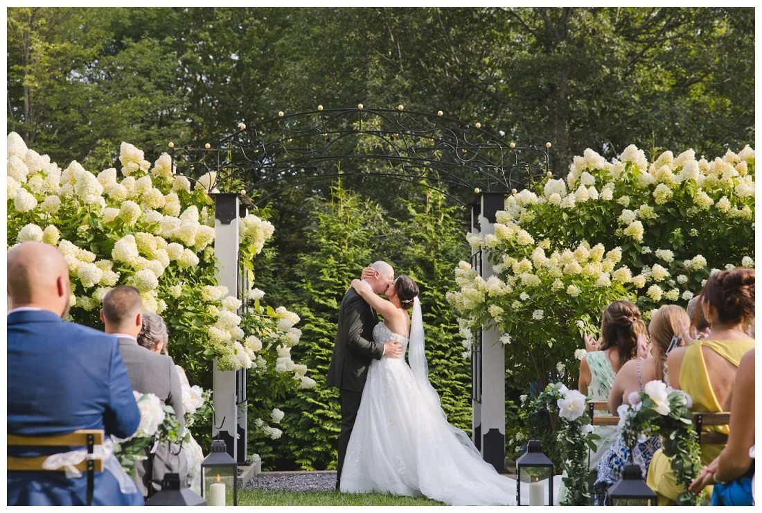 bride and groom first kiss wedding ceremony