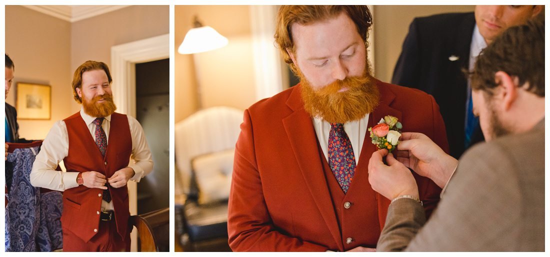 groom buttons up his vest and gets his flowers pinned on his suit jacket