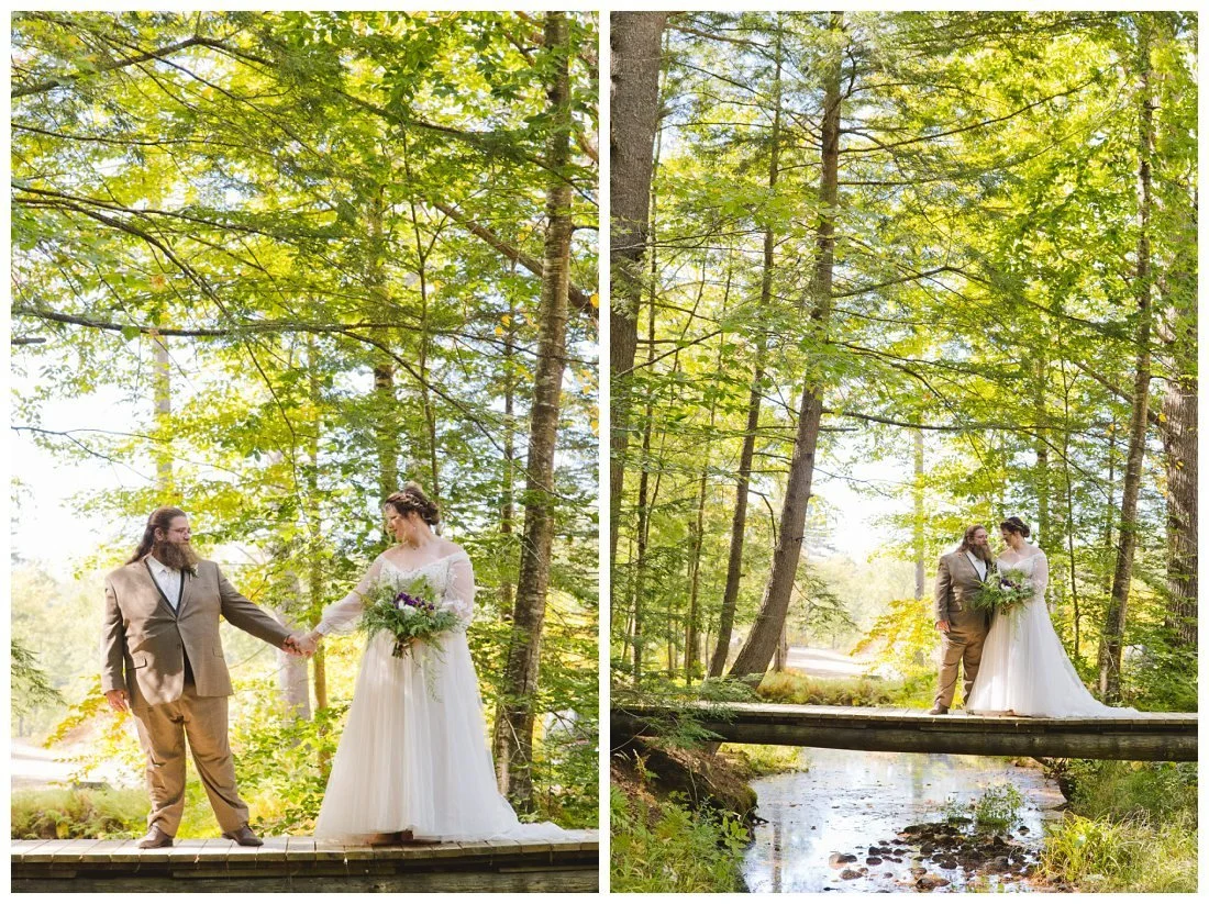 bride and groom hold hands on a bridge over a stream with the golden light shinging through the trees behind them