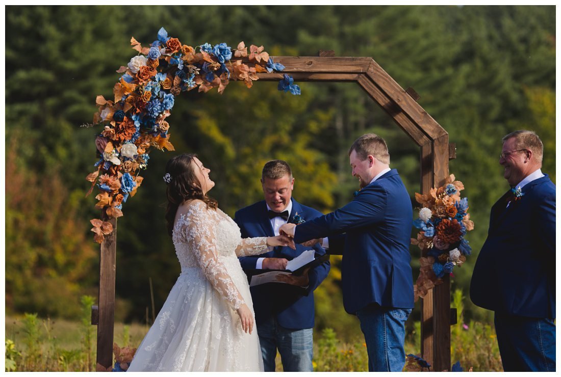 morgan laughing while kaleb is putting her ring on during wedding ceremony
