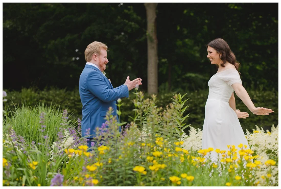 tara throws her arms back to show off her dress during first look