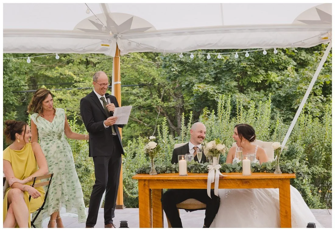 lauren reacts to toast and derek looks at her smiling, father laughs