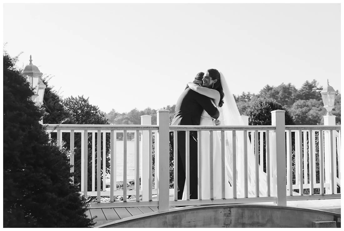 B&W photo of bride and groom hugging after first look