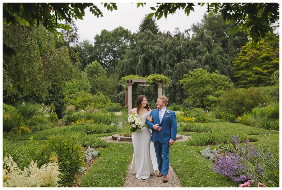 bride and groom walking down the pathway in glen magna gardens
