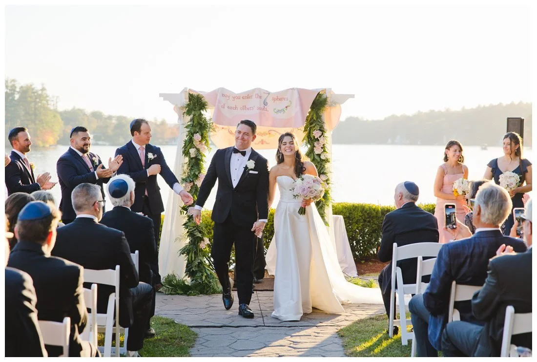 bride and groom with big smiles walk back down the aisle after wedding ceremony at castleton