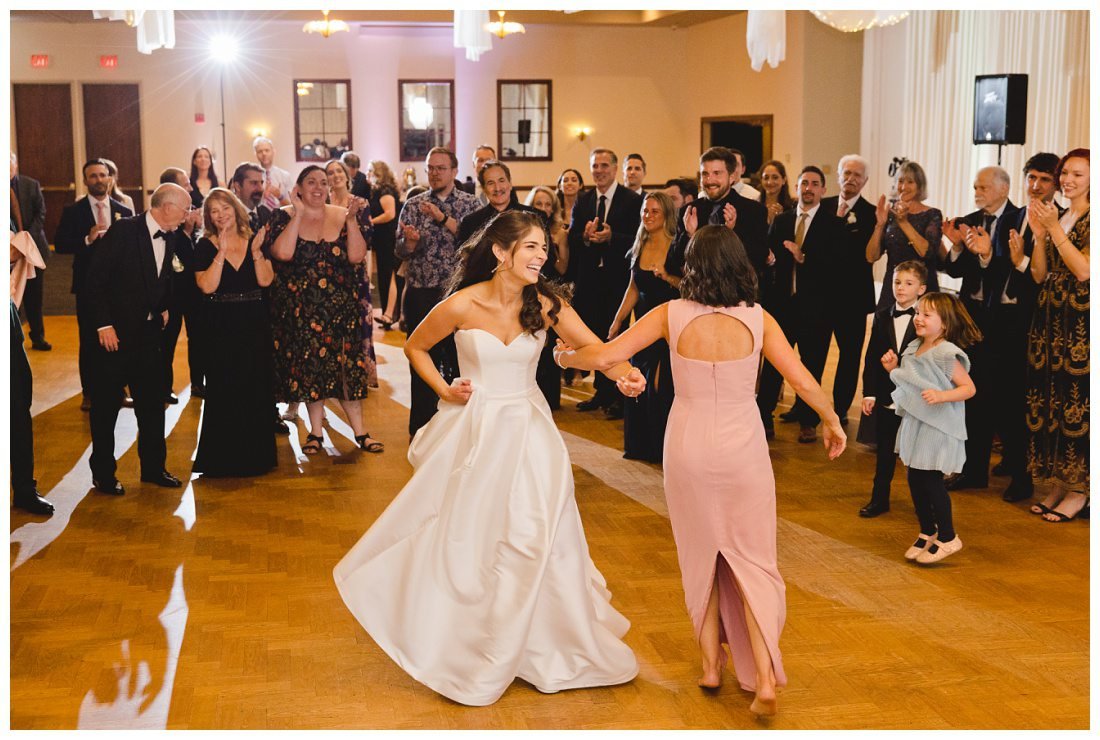 bride dances in the center of the hora circle with her sister