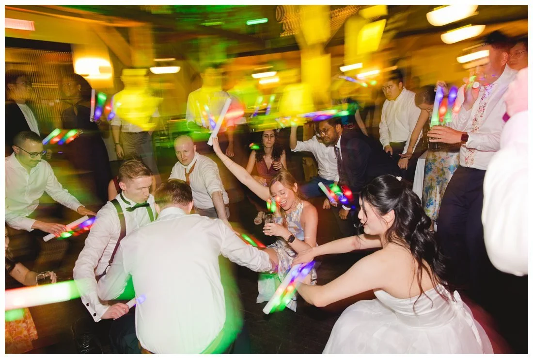 bride and groom get down on the dance floor with their friends