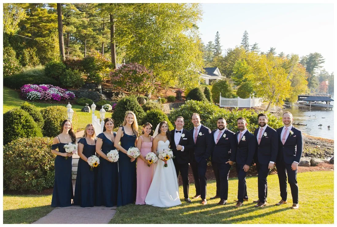 wedding party in front of bridge at castleton with the lake in the background