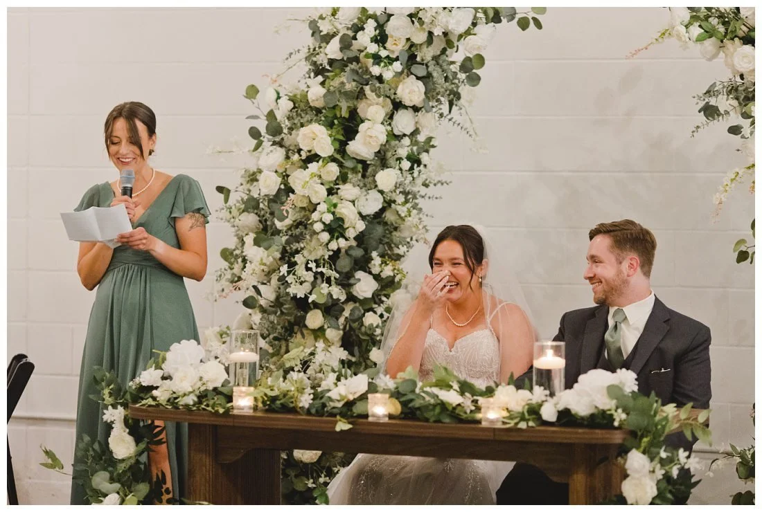 natalie covers her face as her maid of honor gives a toast
