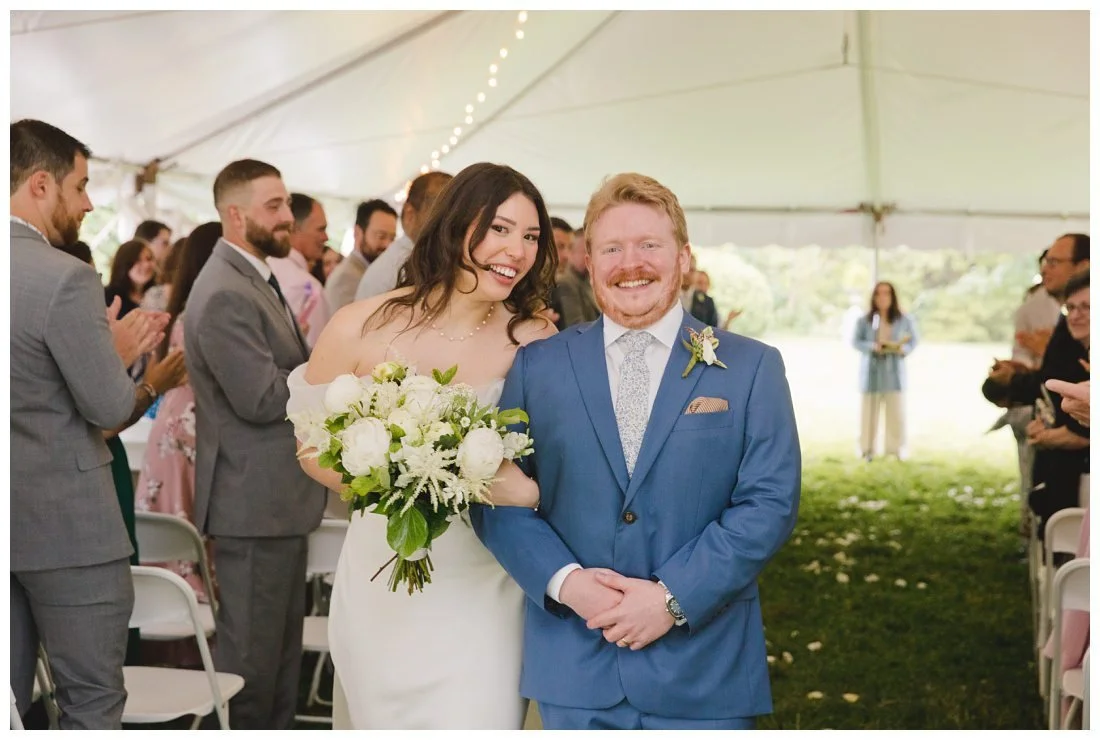big smiles on couple coming back down the aisle after ceremony