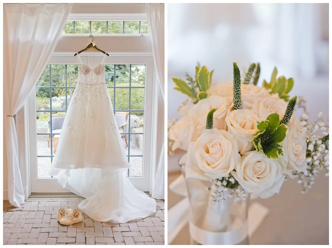 wedding dress with train hanging in front of large french doors at the cottage at uncanoonuc mountain, white rose bouquet with green accents