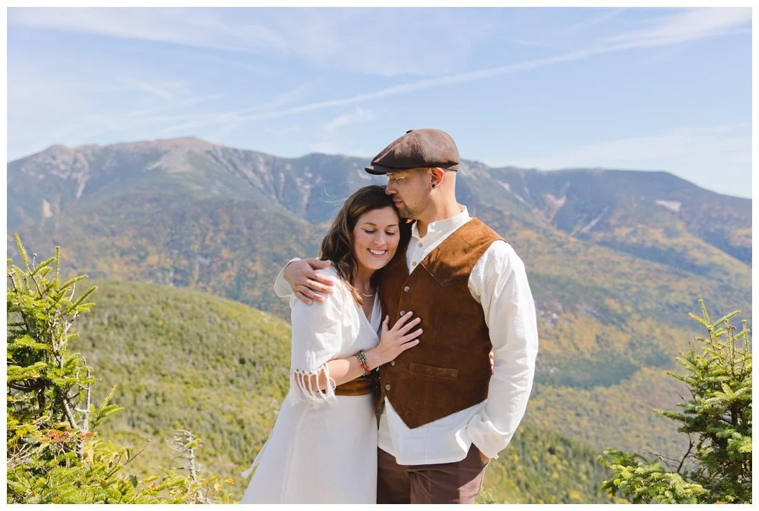 beautiful blue sky and white mountains behind wedding couple