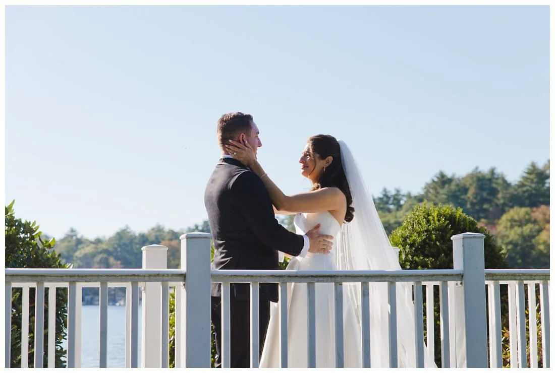 bride looks like she's going to cry during first look while holding groom's face