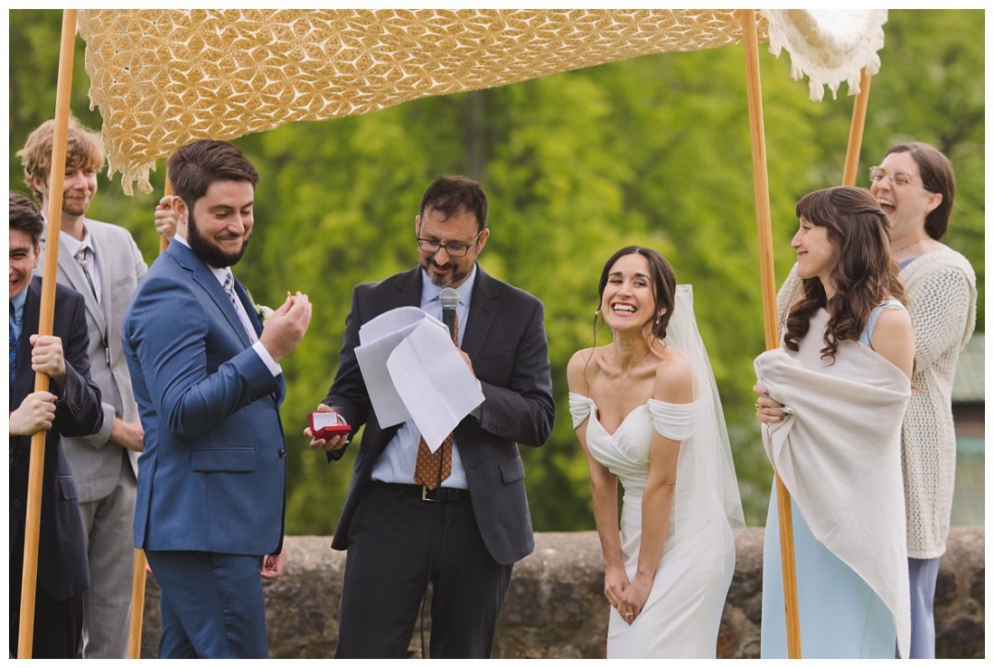 Jon looks at the ring and Mira laughs looking at the guests