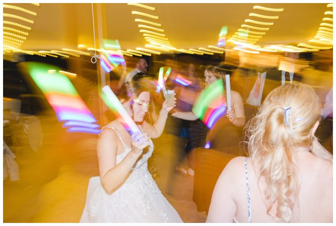 bride on dance floor with light up baton, slow shutter to show light and movement