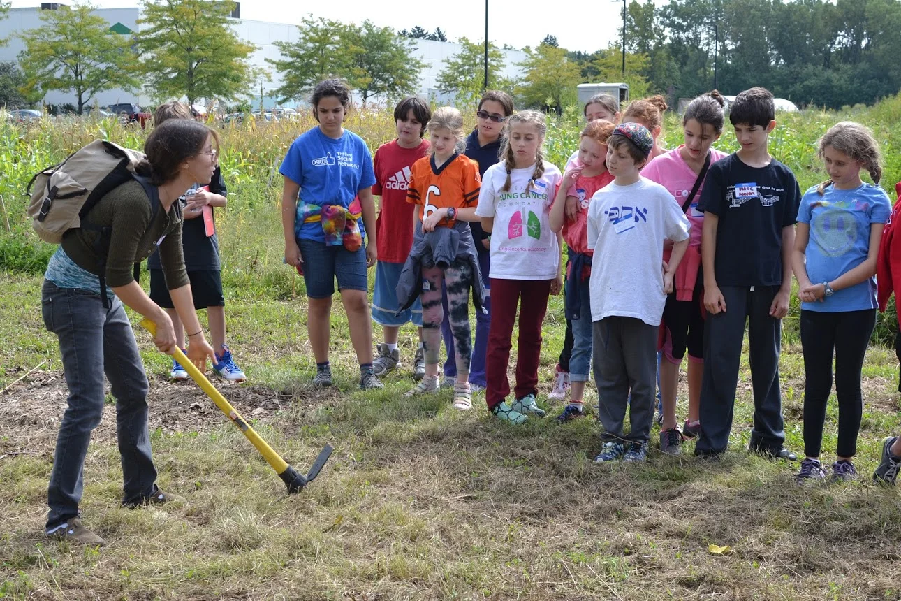 Kate demonstrating how to use a pick-axe.JPG