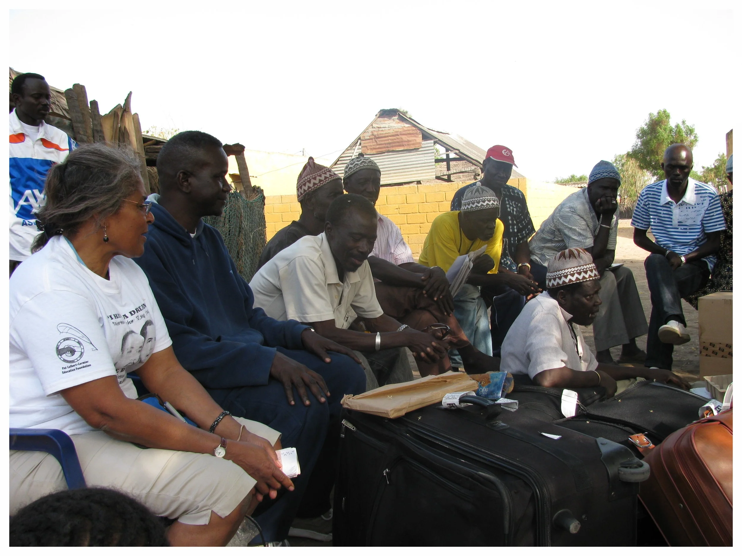 Ms. Patricia Colbert-Cormier and Dr. Seck await to present gifts to the village from the foundation.