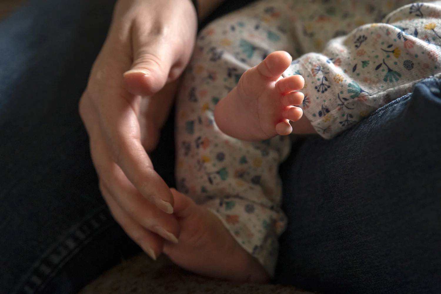  Kimi Francis tickles the feet of her six-week-old daughter, Charlotte, on a quiet Saturday afternoon at home. 