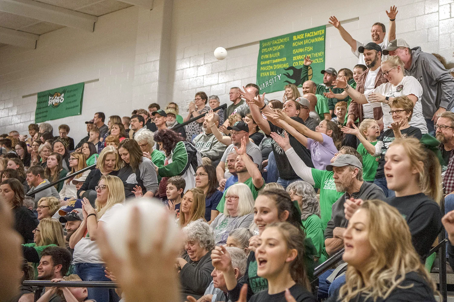  Fans react to cheerleaders throwing souvenirs to the audience during the men's basketball game against Eastern's rival, Southern High School, at Eastern High School just outside of Tuppers Plains. Students from Tuppers Plains and other communities i
