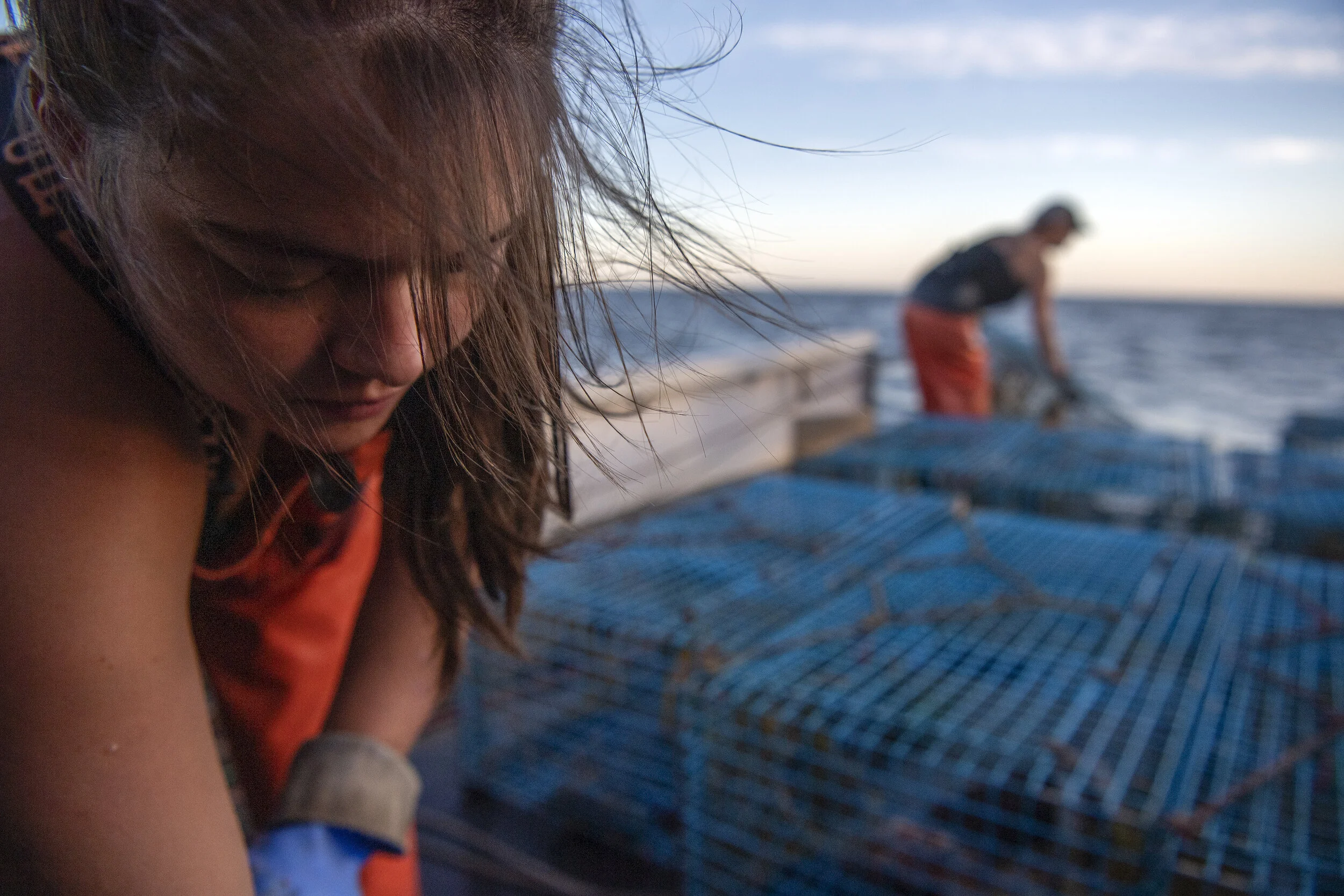  Caroline Howlett secures lobster traps lined with bait onto the back of the lobster boat, Pot Luck, on Cape Cod Bay. It is a line of work fraught with danger, and with no guarantees of good pay. Howlett is one of the few younger people in the region