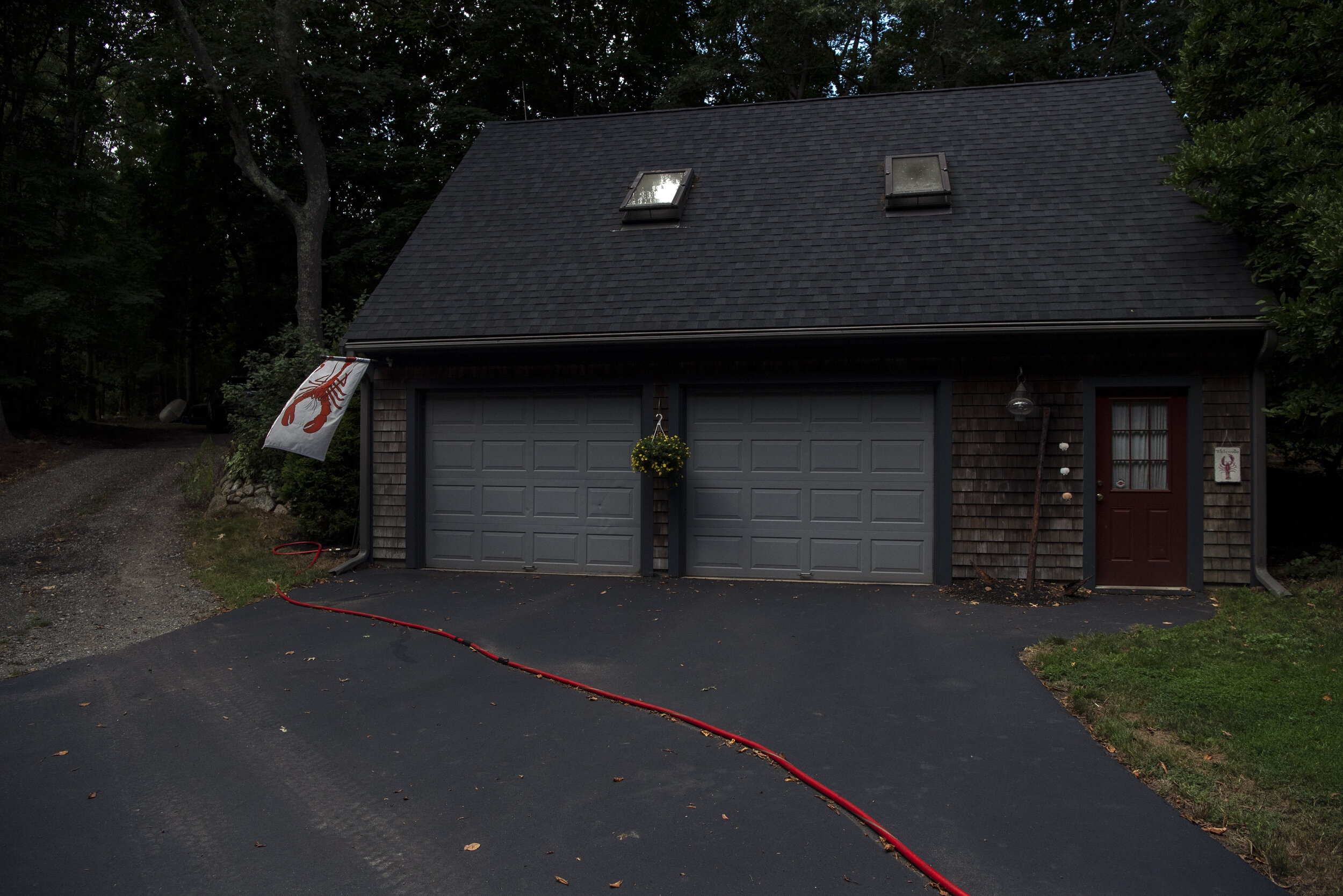 Lobsterman Phil Mason’s garage in Marshfield, Mass., is adorned with a lobster flag waving in the early morning wind.