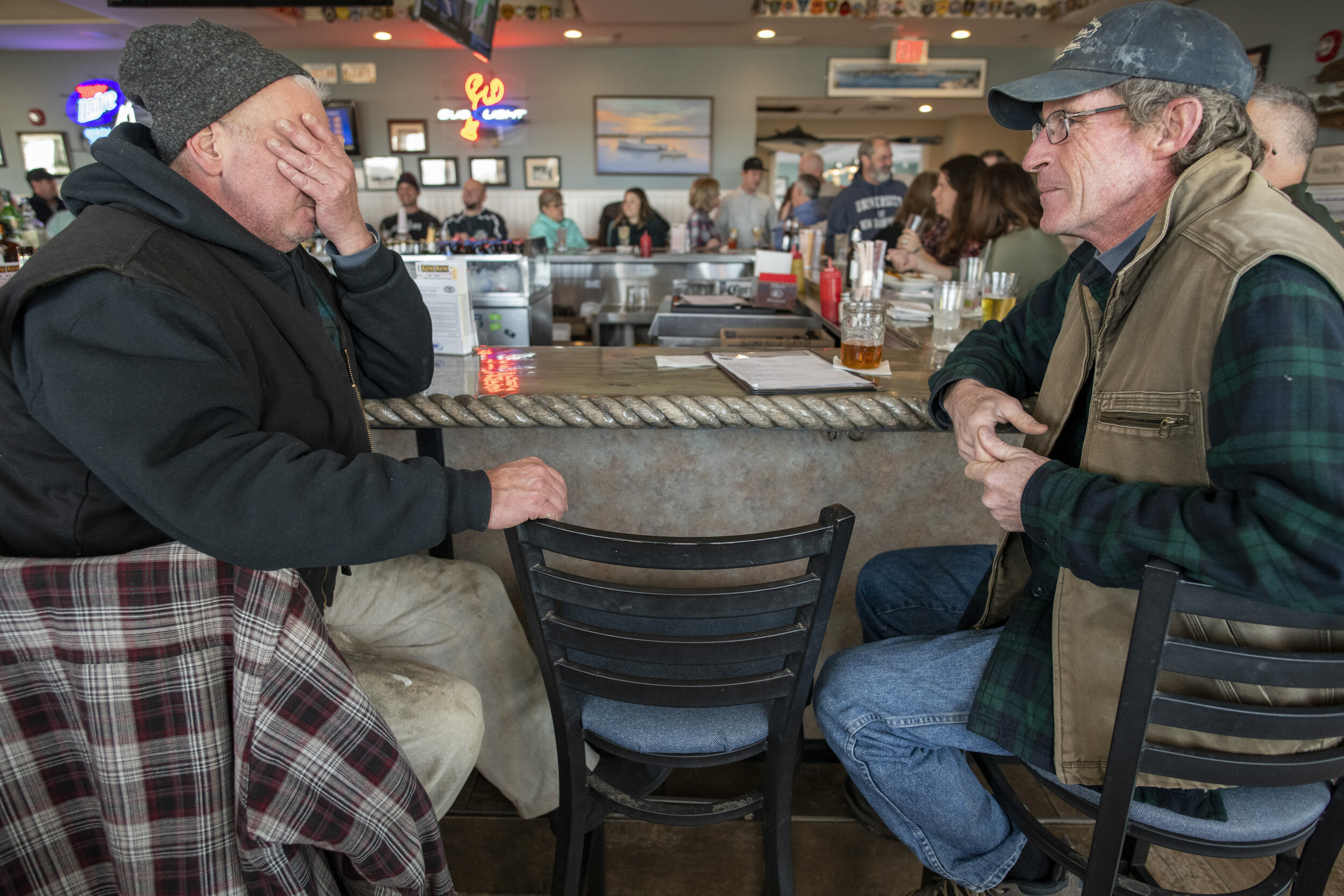 Fishermen Jamie Whittaker, left, and Tim Barrett, share a drink at the Haddad’s Ocean Cafe in Green Harbor, Mass. Haddad’s Bar used to be a fisherman’s hangout. Now it has transformed into more of a sports bar for locals and tourists. Some fishermen