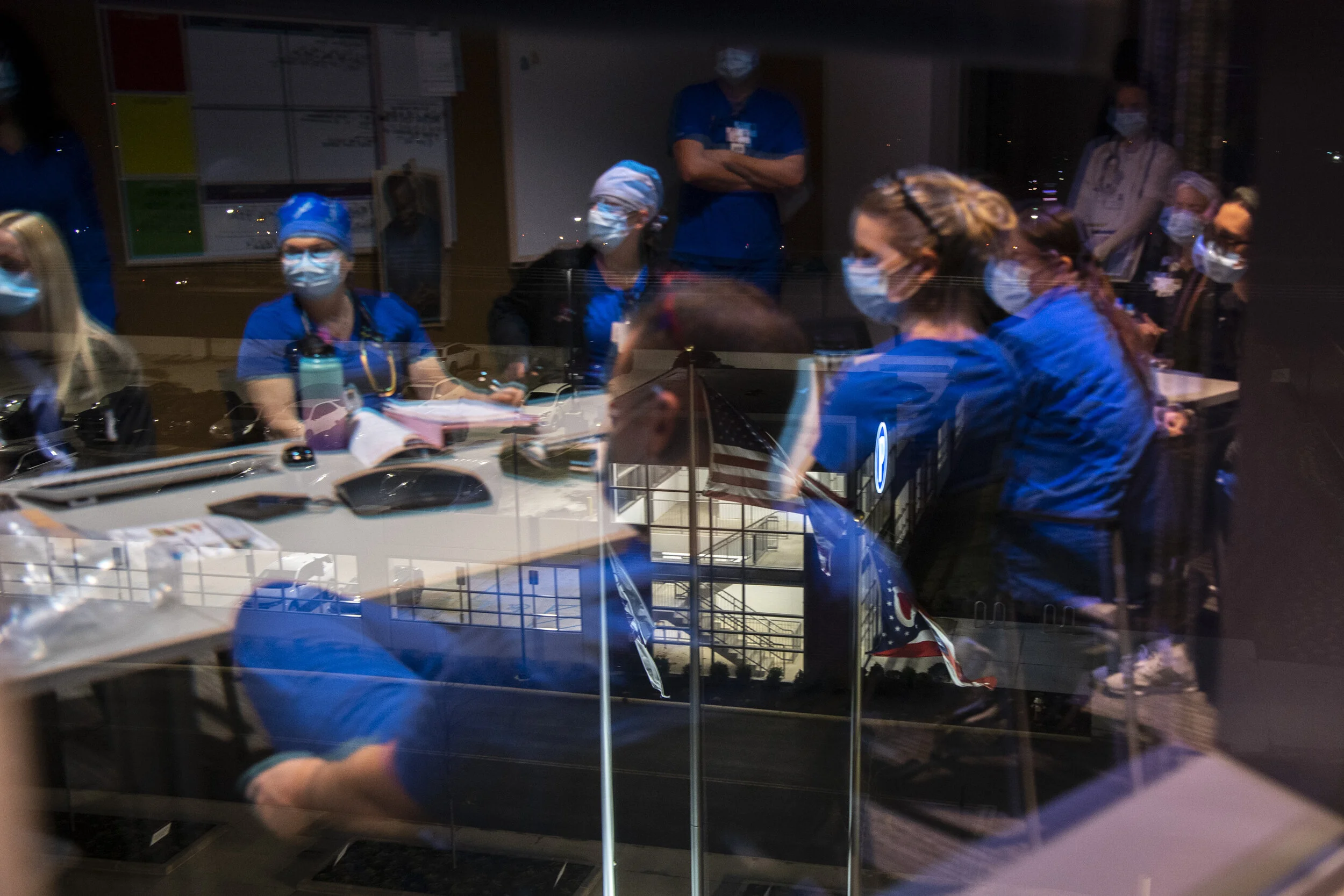  ICU nurses start their 12-hour shift with a huddle and are given updates before rotating with the nurses inside Mount Carmel Grove City Hospital’s COVID-19 ward. 