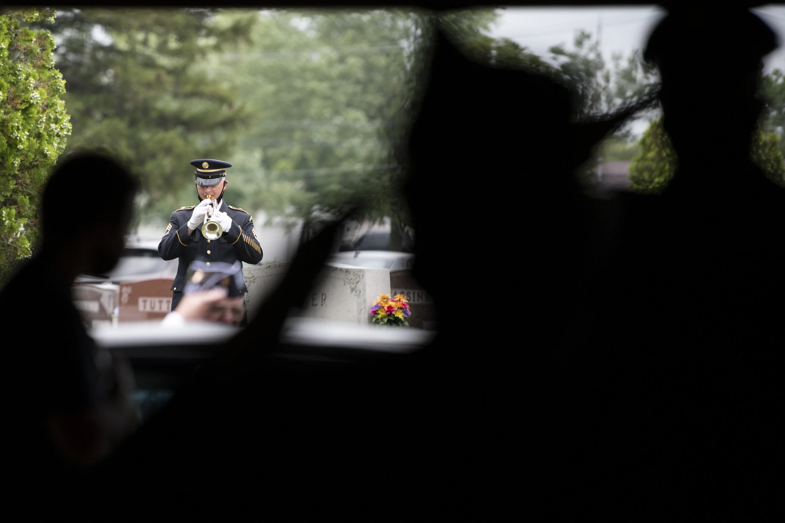  Veterans and soldiers salute as Taps is played during the funeral for Pfc. William Winchester at Memorial Park Cemetery in Lima, Ohio. 