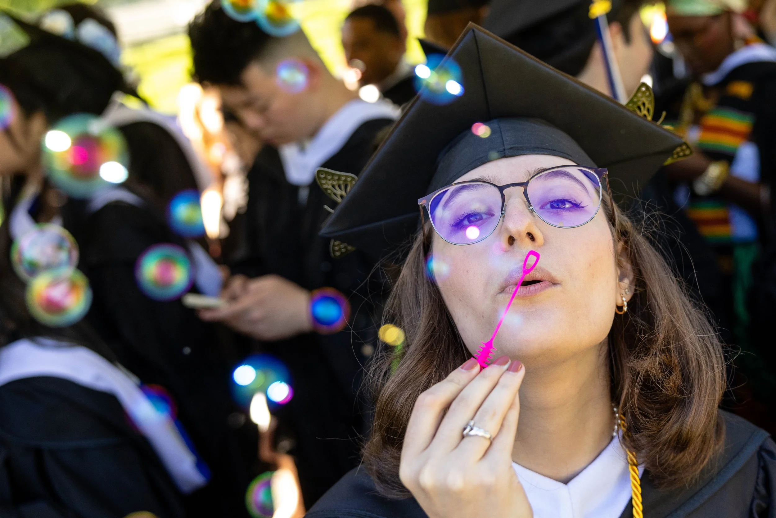  Natasha Girshin blows bubble during commencement celebrations at Brandeis University. 