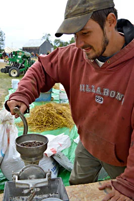 Mike Bouchard grinds buckwheat to make flour, at the Common Ground Country Fair. English photo.