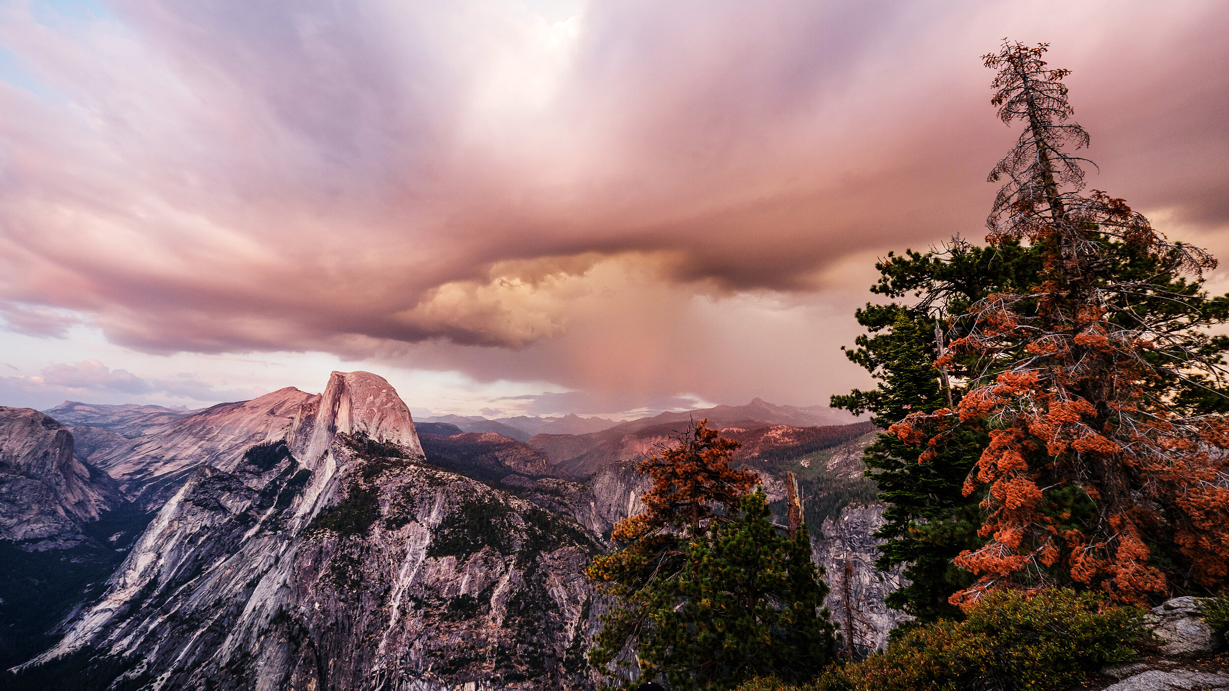 We stayed at Glacier Point until sunset. Right as the sun went down rain clouds rolled in from the east, bathing the granite valley in a soft pink light.