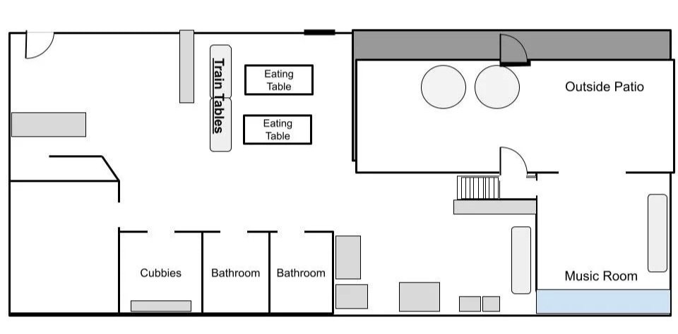 Floor plan of a house with train tables, two eating tables, an outside patio, two bathrooms, a music room, and several seating areas.