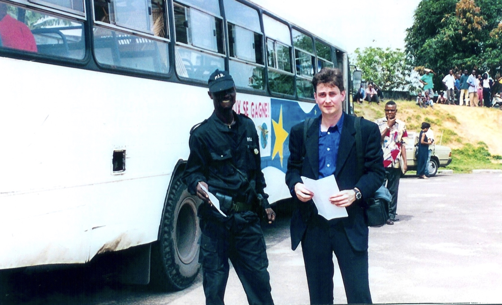 Departure time at the secret refugee compound. Sasha from IOM and Congolese policeman. Photo from Sasha Chanoff Refuge Point.