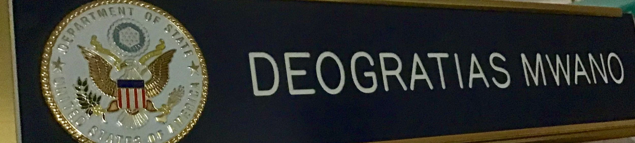 Deo’s desk badge at the National Passport Center
