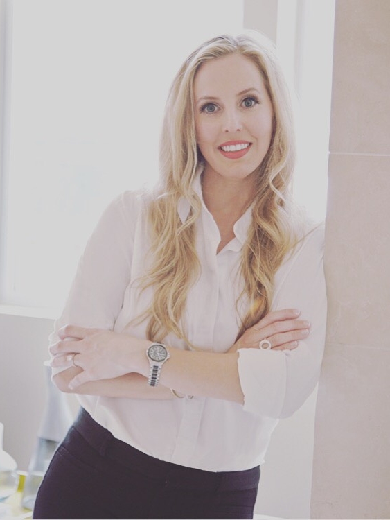 Headshot of Haley Tomlin of Haley Lane Interiors leaning against a wall.jpeg