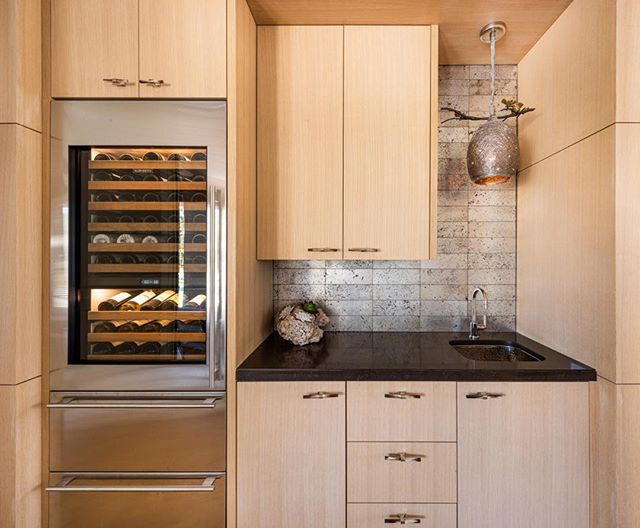 We selected a beautiful Ann Sacks tile with texture to offset the smooth white oak cabinetry. The Ochre horn handles bring in a natural element to tie it all together. Photography by @robertwtsai  @annsacks @ochreochre @michaelaram @subzeroandwolf @k
