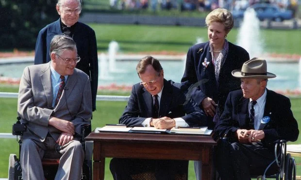 President-George-Bush-signs-the-Americans-with-Disabilitites-Act-in-the-White-House-Rose-Garden-July-26-1990-Article-201809181905.jpg