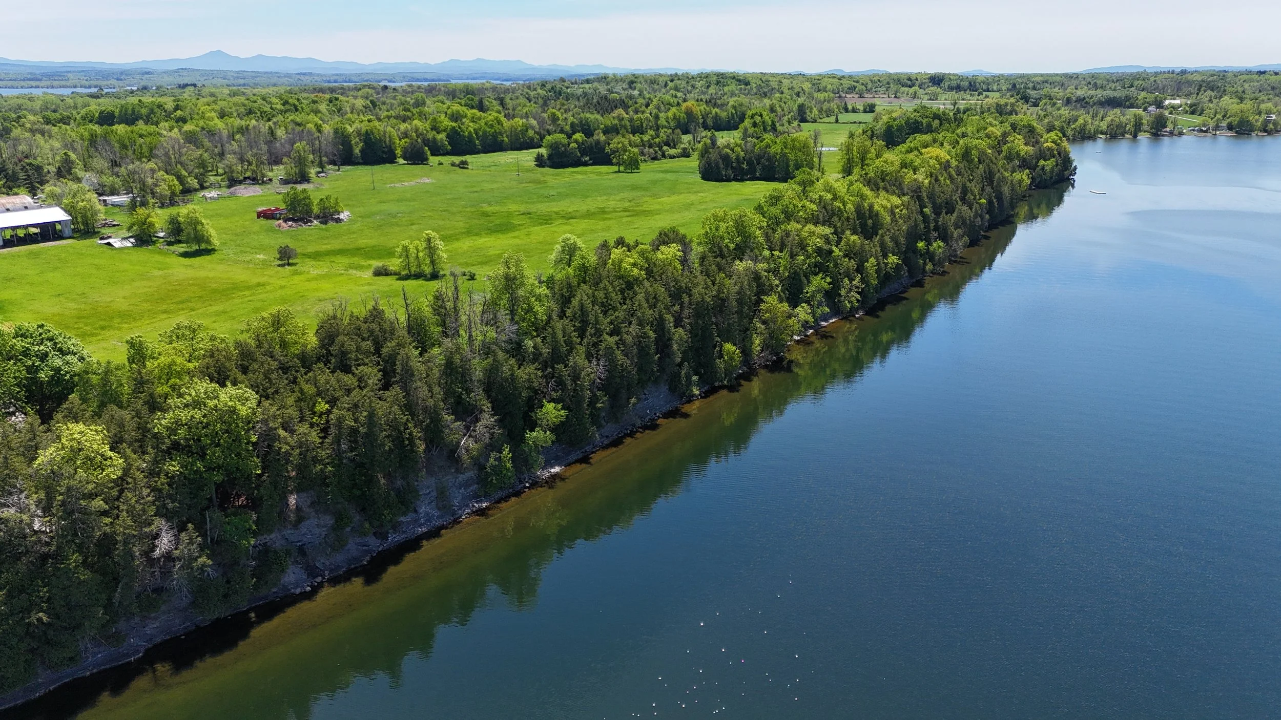 drone photo of the Lalumiere property, with the Green Mountains in the distance